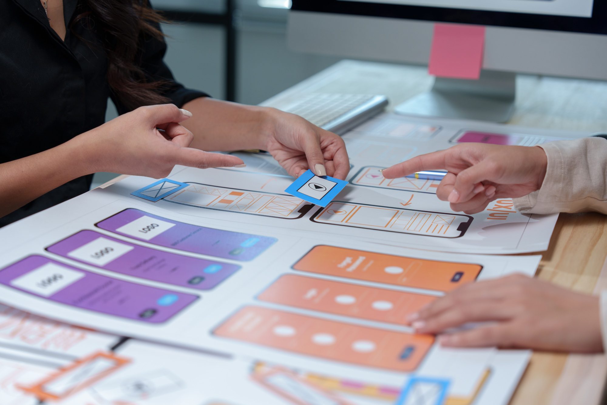 Web designers are discussing user experience and user interface details for a new mobile application
